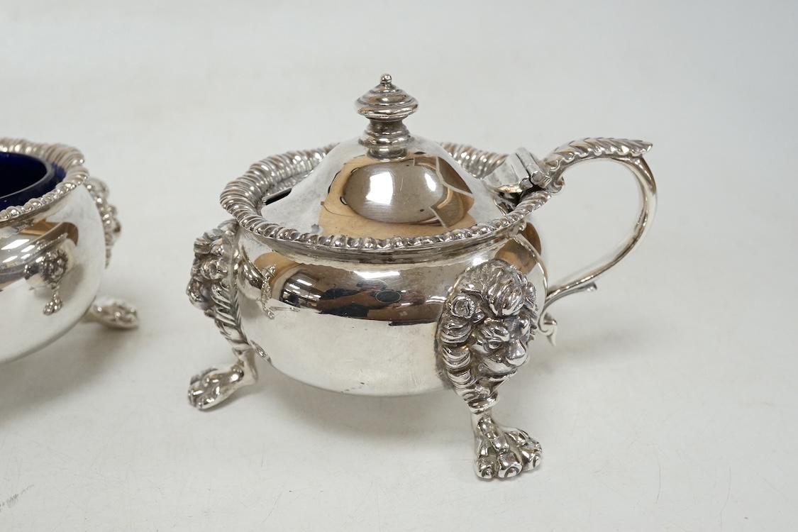 A George VI silver three piece condiment set by Mappin & Webb, London, 1937, with blue glass liners, one associated, pepper, 13.9cm, 26.5oz.